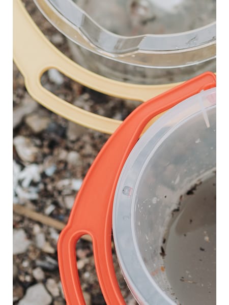 Tre gennemsigtige skovle med farvede kanter i blå, gul og rød